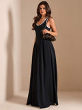 Monochrome sleeveless maxi dress styled with shoulder bag