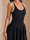 Black dress close-up with scoop neck and basque waist