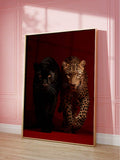 Large framed big cat print with black panther and leopard against pink paneled wall