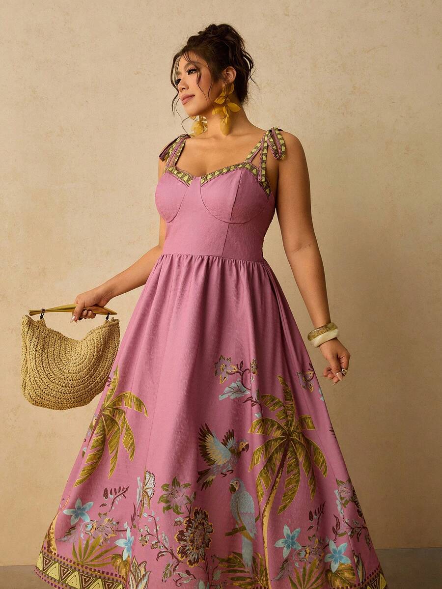 Three-quarter view of pink tropical tie strap dress with full skirt