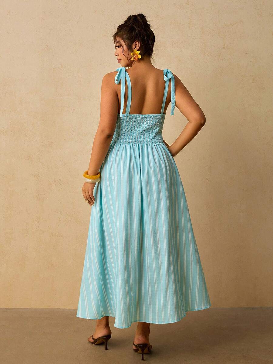 Back view of aqua striped tie strap dress with smocked bodice
