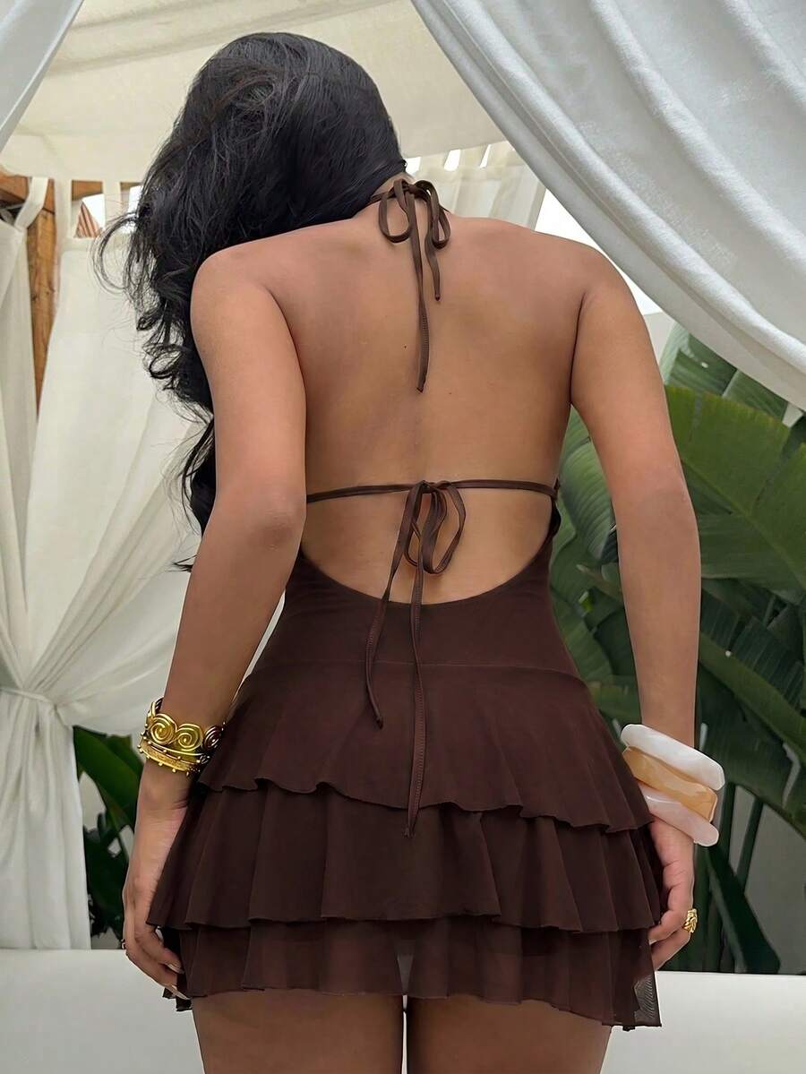 Styled view of shell trim halter ruffle mini dress showing visible color, trim, and silhouette