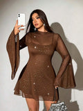 Rear view of black embellished cover-up dress showing sheer back and flared sleeves