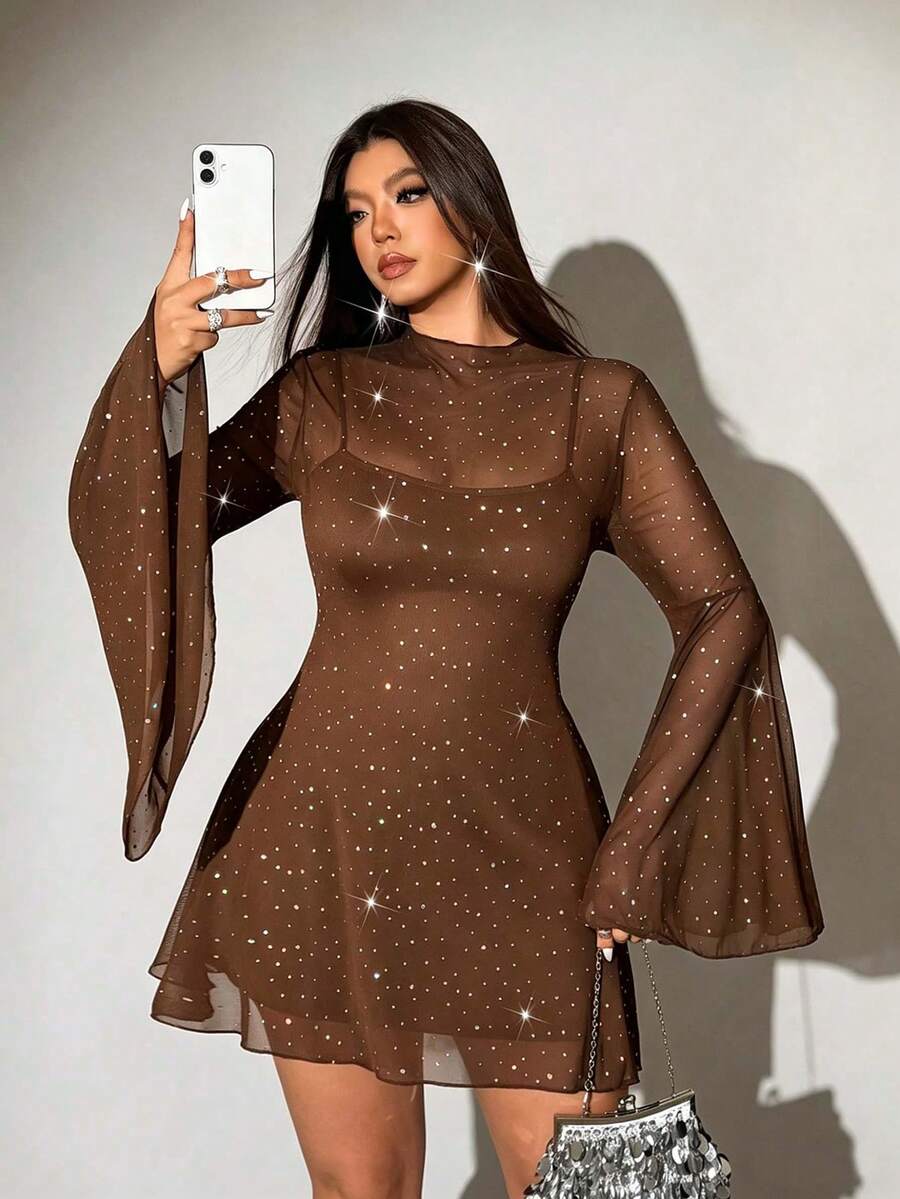Rear view of black embellished cover-up dress showing sheer back and flared sleeves