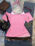 Back flat lay of pink off-shoulder top with striped tie-neck layer and curved outer hem