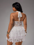 Back view of white lace halter dress with neck tie and tiered skirt