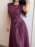 Close front view of dark plum cap-sleeve maxi dress with knotted belt