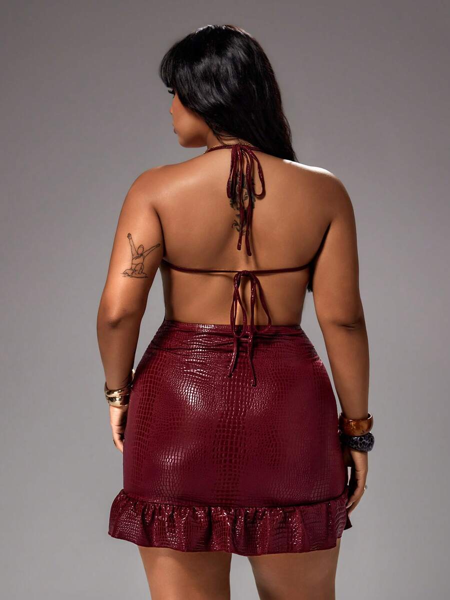 plus size burgundy croc embossed halter mini dress with glossy faux leather texture, cowl draped neckline, open tie back, spaghetti straps, ruched bodycon fit and ruffle flounce hem image 2