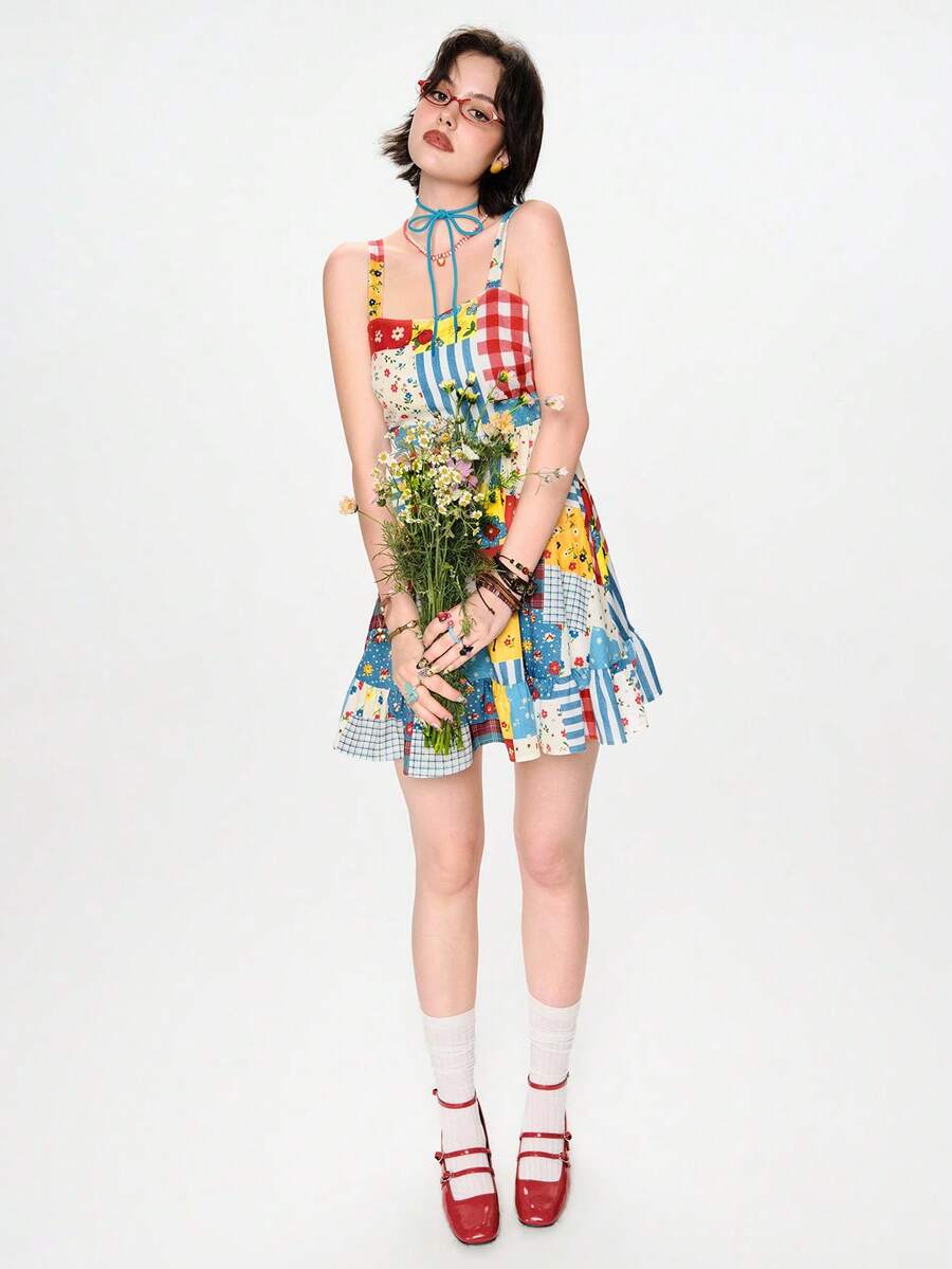Full front model view of multicolor patchwork babydoll mini dress with wide straps and ruffle hem