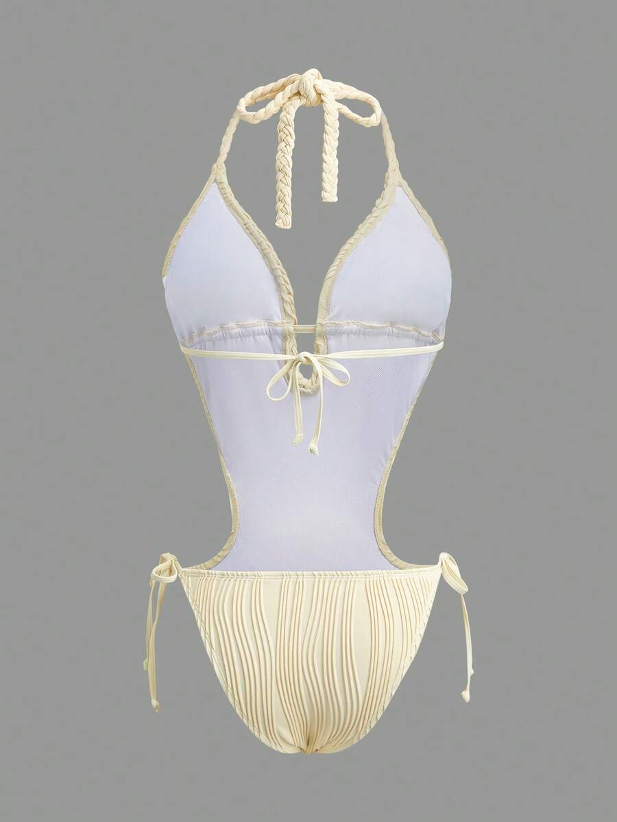Back studio view of ivory halter cutout one-piece swimsuit with open back and tie details for beach party styling