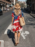 Back view of red white and navy patriotic tiered mini dress with puff sleeves