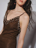 Back view of brown beaded spaghetti strap knit maxi dress showing visible color, trim, and silhouette