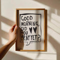 Hand-held light wood framed black-and-white prayer wall art poster with Good Morning Did You Pray Yet message