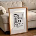 Light wood framed Good Morning Did You Pray Yet inspirational poster beside a sofa in a living room