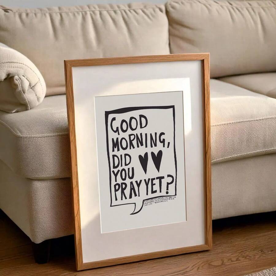 Light wood framed Good Morning Did You Pray Yet inspirational poster beside a sofa in a living room