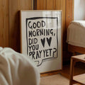 Light wood framed Good Morning Did You Pray Yet Christian typography wall art against a wood bedroom wall