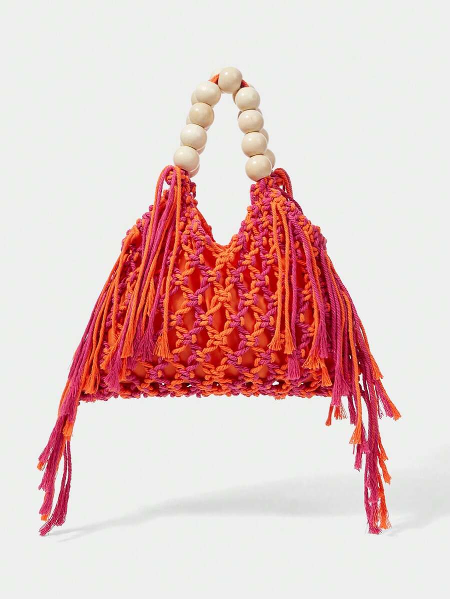 Orange and pink crochet beach bag on white background with hollow knit fringe sides and bead handle
