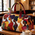 Front cafe view of multicolor quilted duffle bag with African figure portrait art