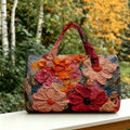 Outdoor front view of floral quilted duffle bag with double handles