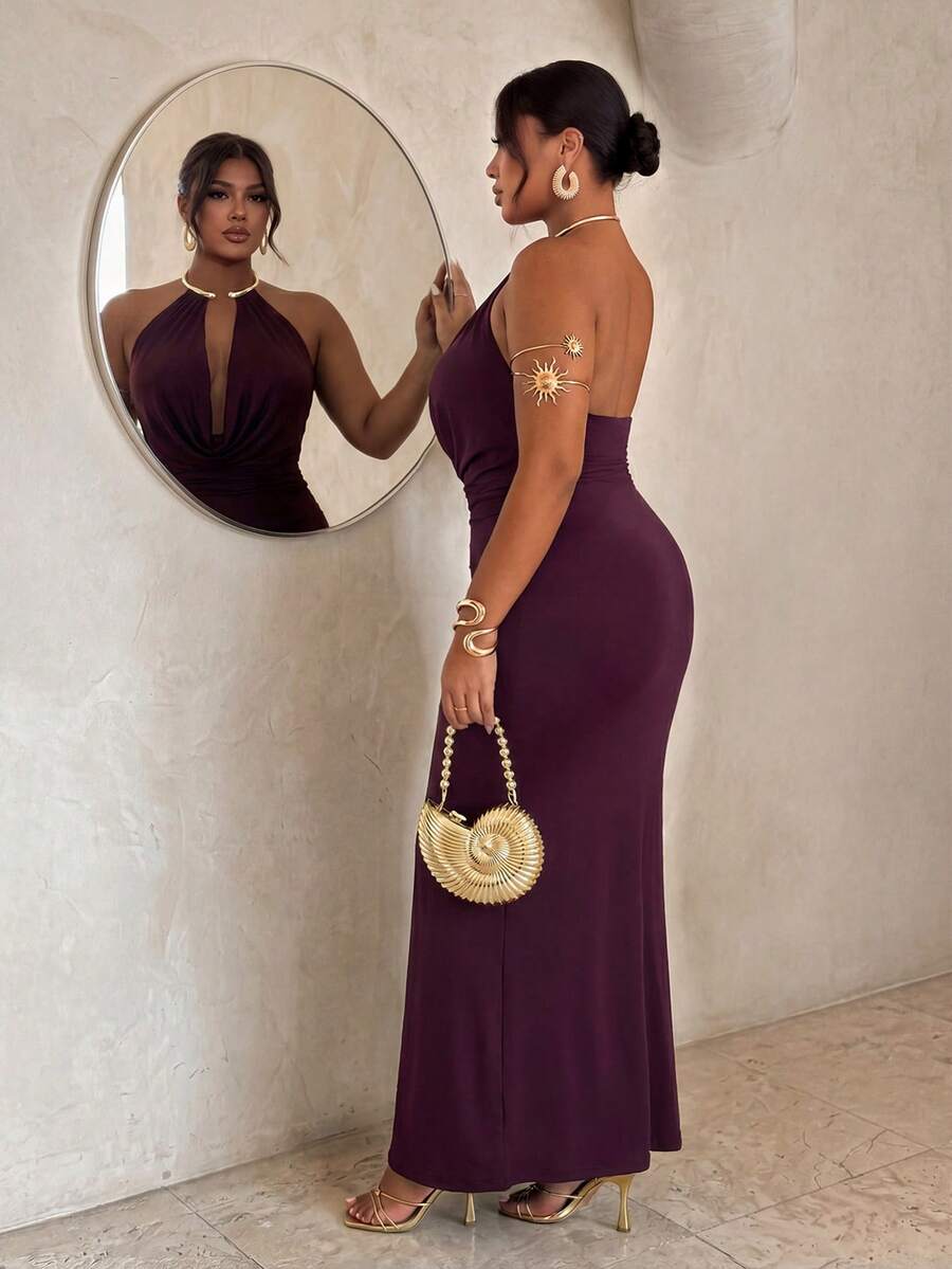 Side back view of plum backless halter maxi dress with fitted long skirt