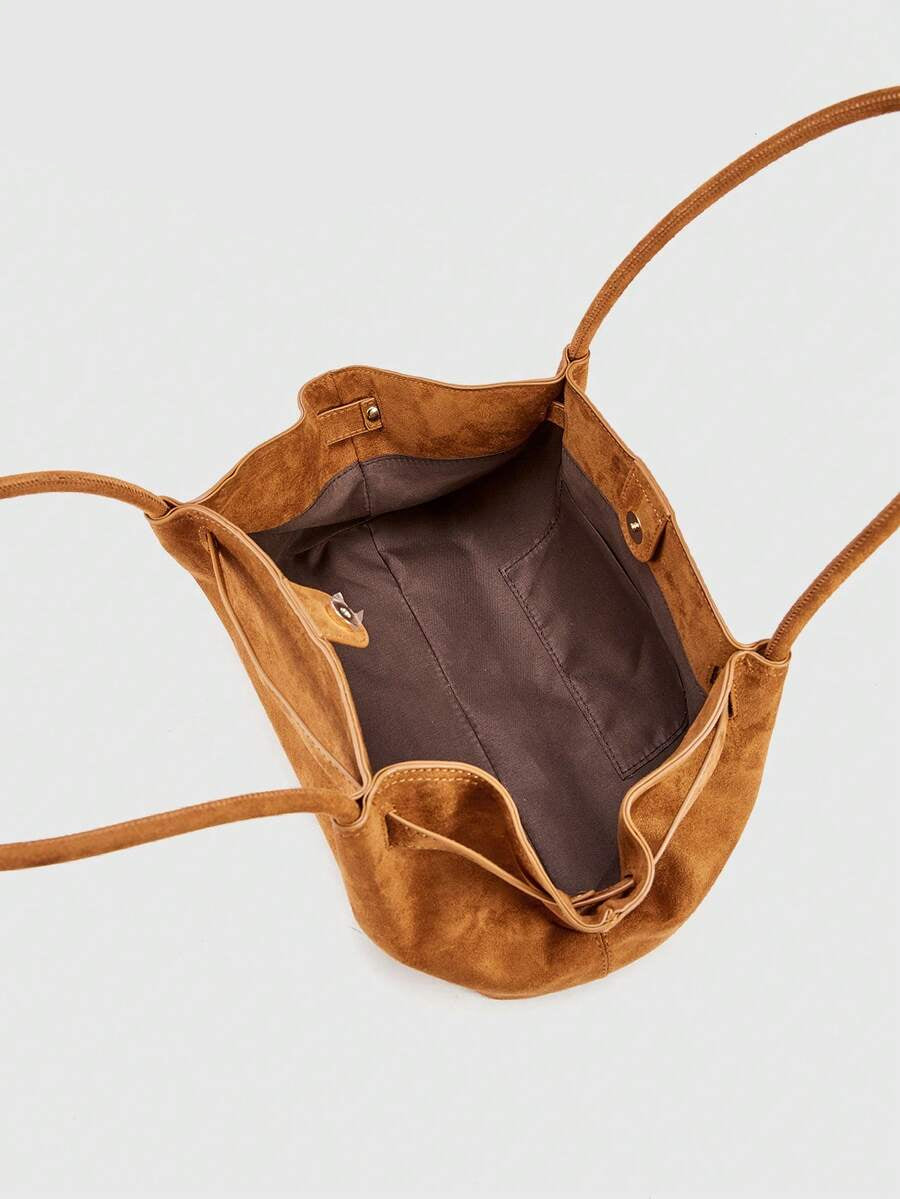Top interior view of brown suede tote bag with open top lining and inner pocket