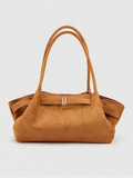 Front view of cognac brown suede tote bag with double handles and silver buckle strap
