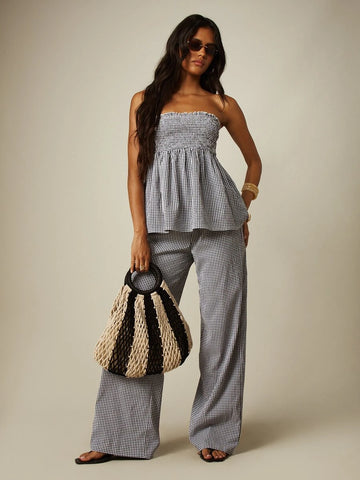 Front view of black white gingham two piece set with strapless smocked bandeau top and wide leg pants