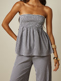 Angled front view of gingham bandeau top and wide leg pants set with ruffle hem