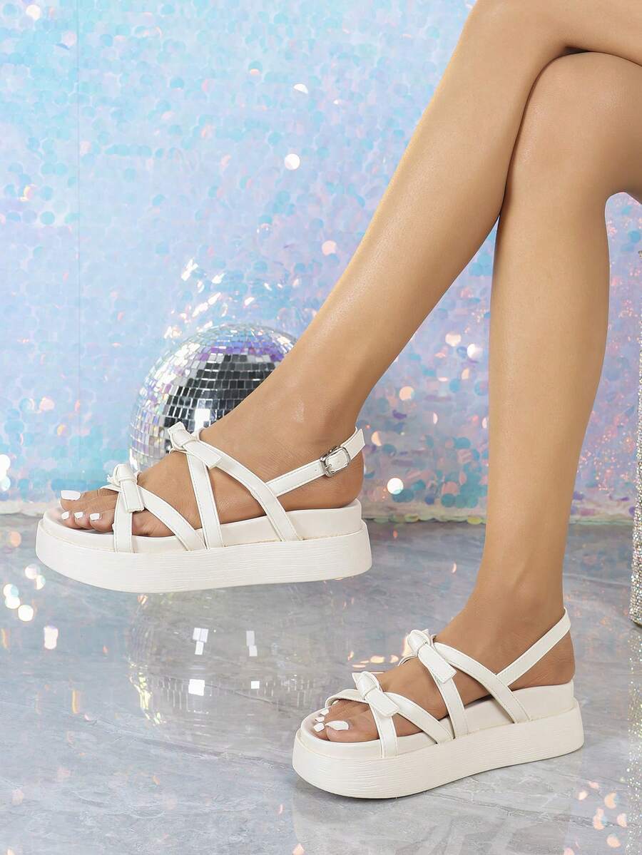 White open toe platform sandals front side view showing crossed straps and summer styling