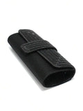 Side angle black glitter envelope clutch showing rounded gusset flap and center tab