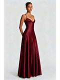 Three-quarter view of the burgundy gown showing fitted bodice and flowing skirt