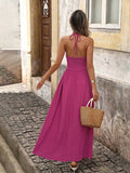 Back view of hot pink boho halter maxi dress with open back and halter tie