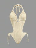 Front studio view of ivory halter studded cutout one-piece swimsuit with deep V neckline and hip ties for beach party styling