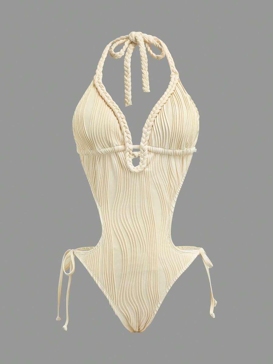 Front studio view of ivory halter studded cutout one-piece swimsuit with deep V neckline and hip ties for beach party styling