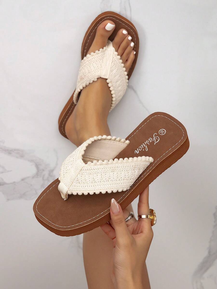 Overhead brown flip-flops with ivory textured V-straps shown worn and held