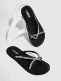 Oblique studio view of black rhinestone thong flip flops as a pair