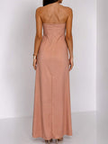 Front view of blush maxi dress with large orange floral print and strapless fitted bodice for summer events