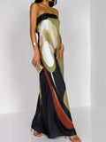 Three-quarter front view of olive, cream and black abstract-print strapless maxi dress for resort styling