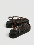 Brown slingback platform sandals rear side view showing ankle buckle and heel strap