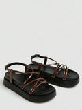 Brown glossy crisscross flatform sandals studio view with black footbed and buckle strap