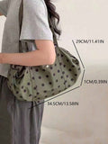 Olive green black polka dot shoulder tote bag on model with size labels showing 34.5 cm length and 29 cm height