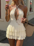 Styled view of shell trim halter ruffle mini dress showing visible color, trim, and silhouette