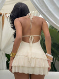 Styled view of shell trim halter ruffle mini dress showing visible color, trim, and silhouette