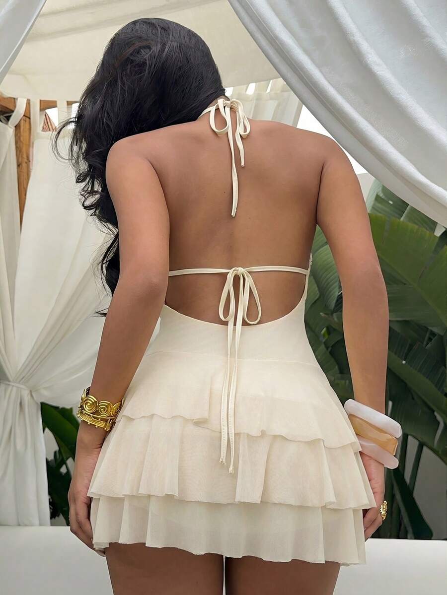 Styled view of shell trim halter ruffle mini dress showing visible color, trim, and silhouette