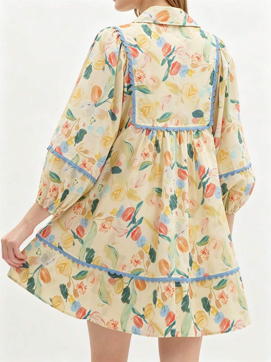 Front view of yellow boho floral babydoll mini dress with blue scalloped trim