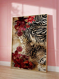Framed leopard and zebra pattern canvas art with burgundy flowers against a pink wall