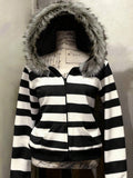 Front view of black and white striped hooded zip-up jacket with faux-fur trim