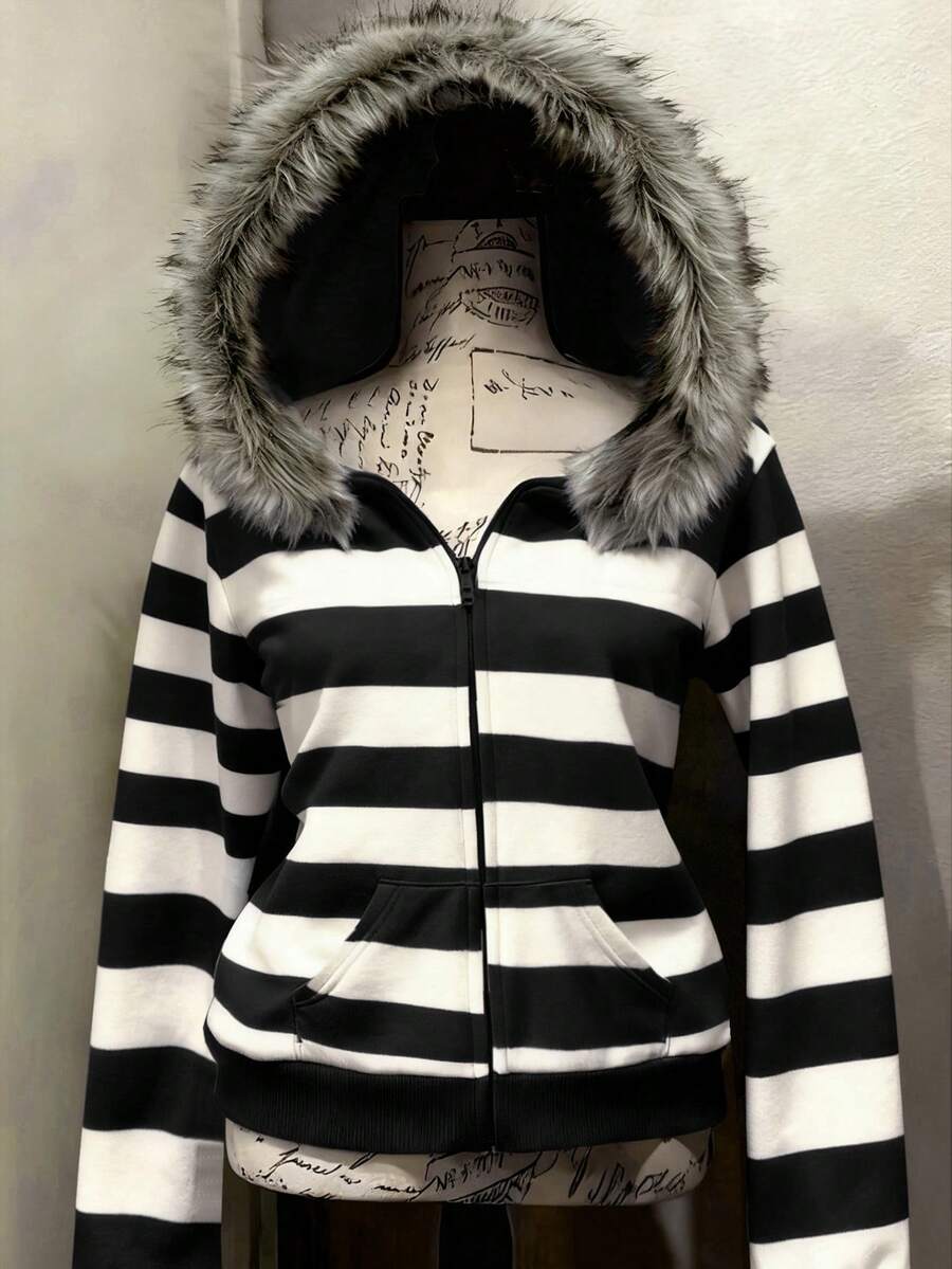 Front view of black and white striped hooded zip-up jacket with faux-fur trim
