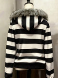 Back view of black and white striped hooded zip-up jacket with faux-fur trimmed hood