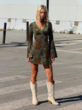 Full front view of green floral faux-wrap mini dress with high waist and long bell sleeves